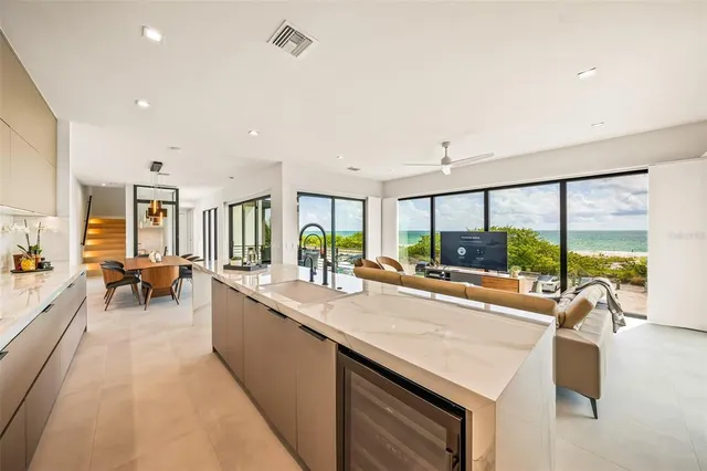 a living room with furniture and large windows