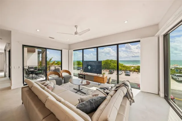 a living room with furniture and a floor to ceiling window