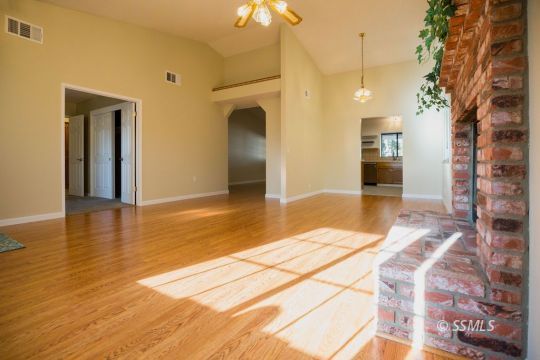 608 Amanda Street Ridgecrest, CA 93555 - Photo 8 of 30 a view of a hallway with wooden floor and a chandelier