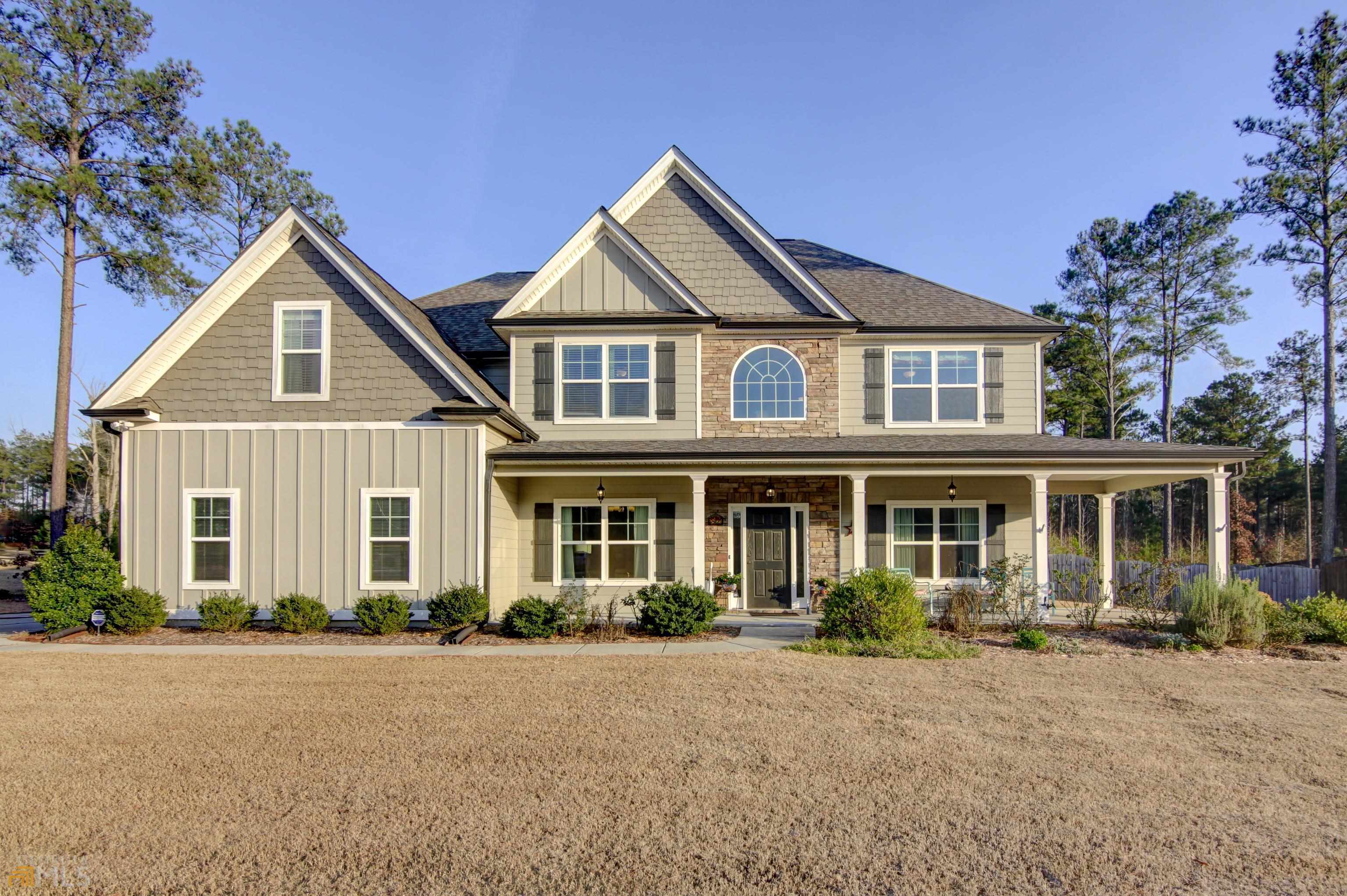 82 Newberry Ests Crossing Senoia, GA 30276 - Photo 1 of 1 a front view of a house with a garden