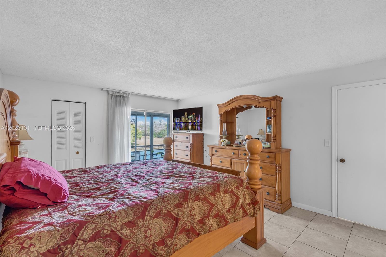 3551 Inverrary Drive, Unit 208 Lauderhill, FL 33319 - Photo 9 of 34 a bedroom with a bed and dresser with mirror