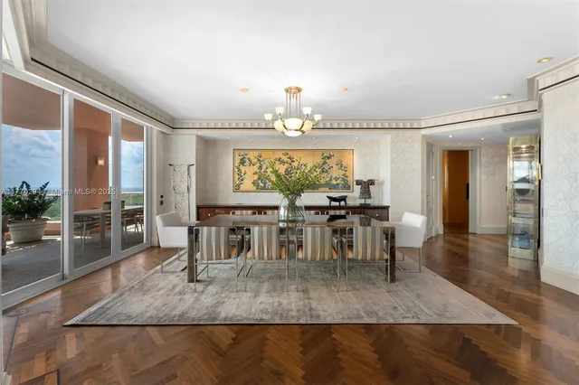 a view of a a dining room with furniture window and wooden floor