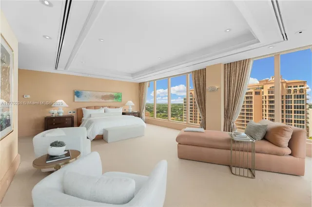 a bedroom with furniture and a large window