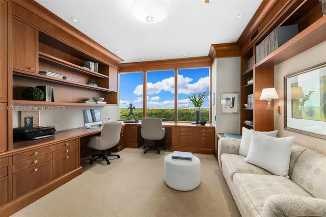 a living room with furniture and a floor to ceiling window