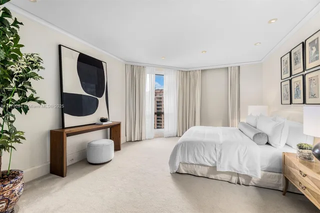 a bedroom with a bed and a potted plant