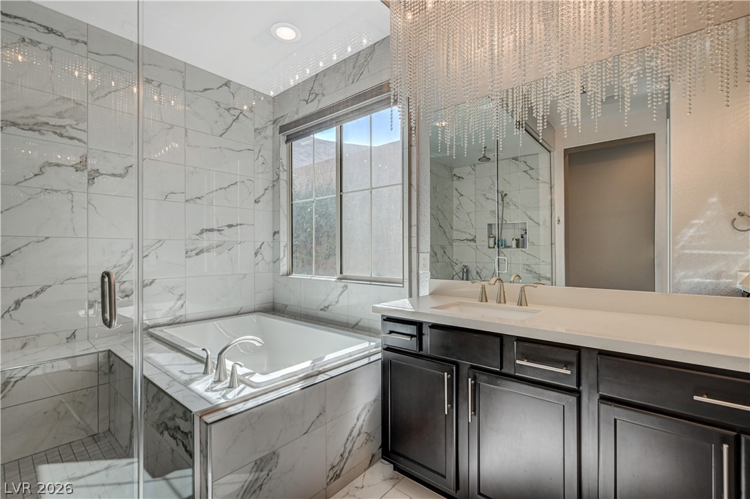 3943 Reyes Avenue Las Vegas, NV 89141 - Photo 35 of 95 Luxurious bathing quarters with a built-in tub and vanity.