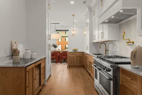 a kitchen with stainless steel appliances a sink stove and cabinets