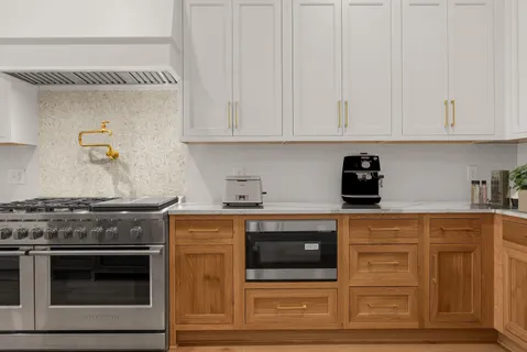 a stove top oven sitting inside of a kitchen