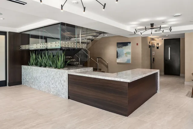 a view of living room kitchen with stainless steel appliances kitchen island a living room and living room view