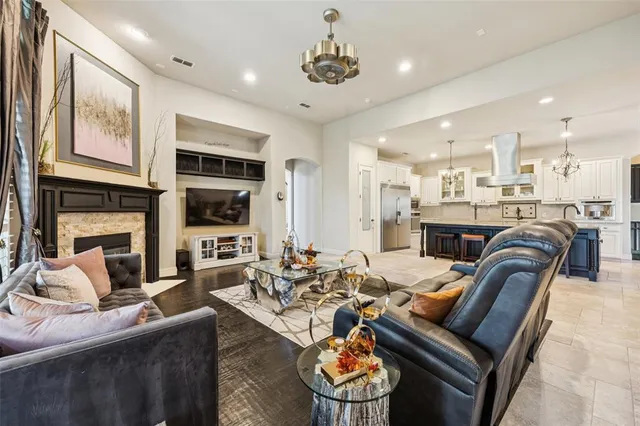 a living room with fireplace furniture and a flat screen tv