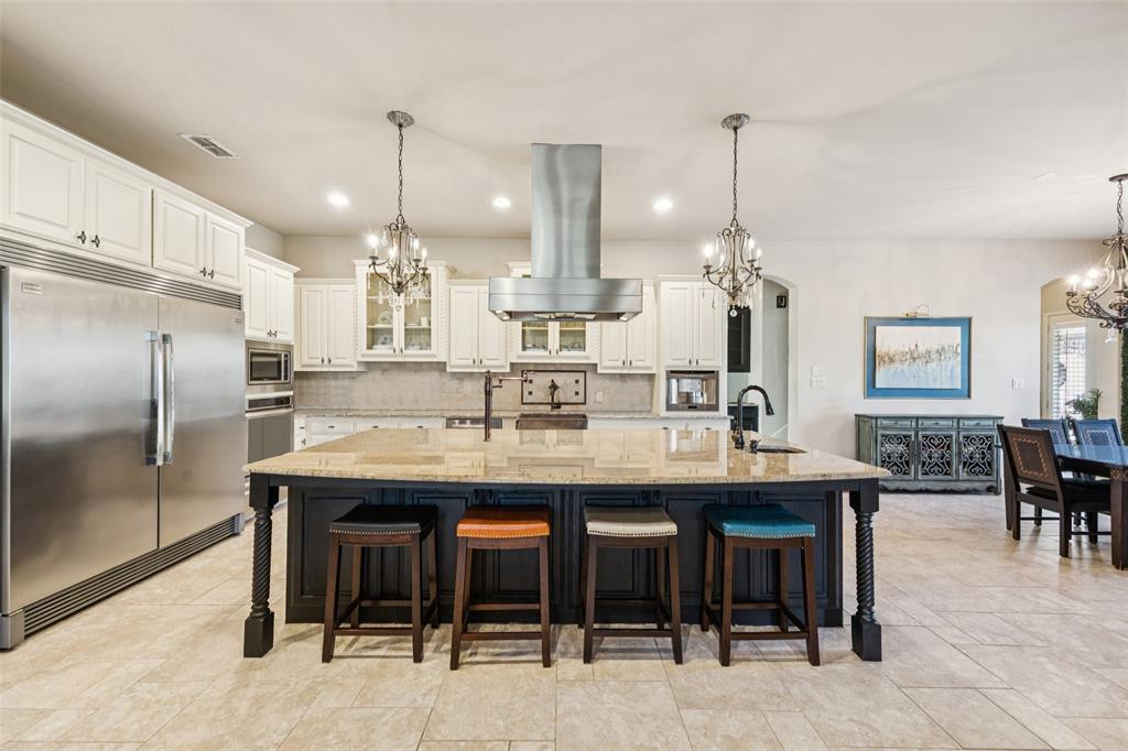 715 Simmons Road Double Oak, TX 75077 - Photo 12 of 40 a large kitchen with a table and chairs