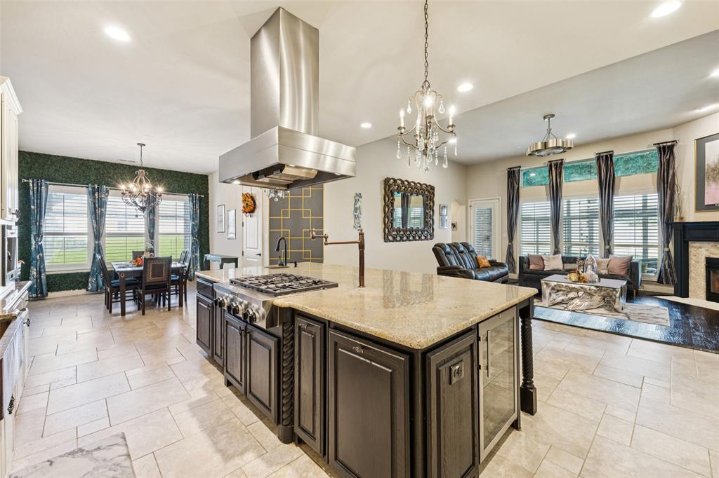715 Simmons Road Double Oak, TX 75077 - Photo 14 of 40 a large kitchen with a table and chairs