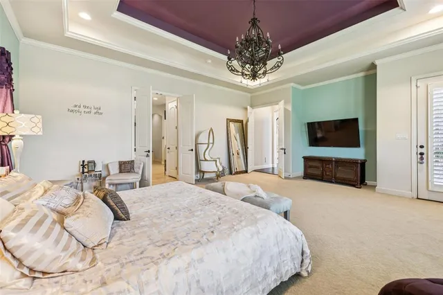 a spacious bedroom with a bed and a flat screen tv