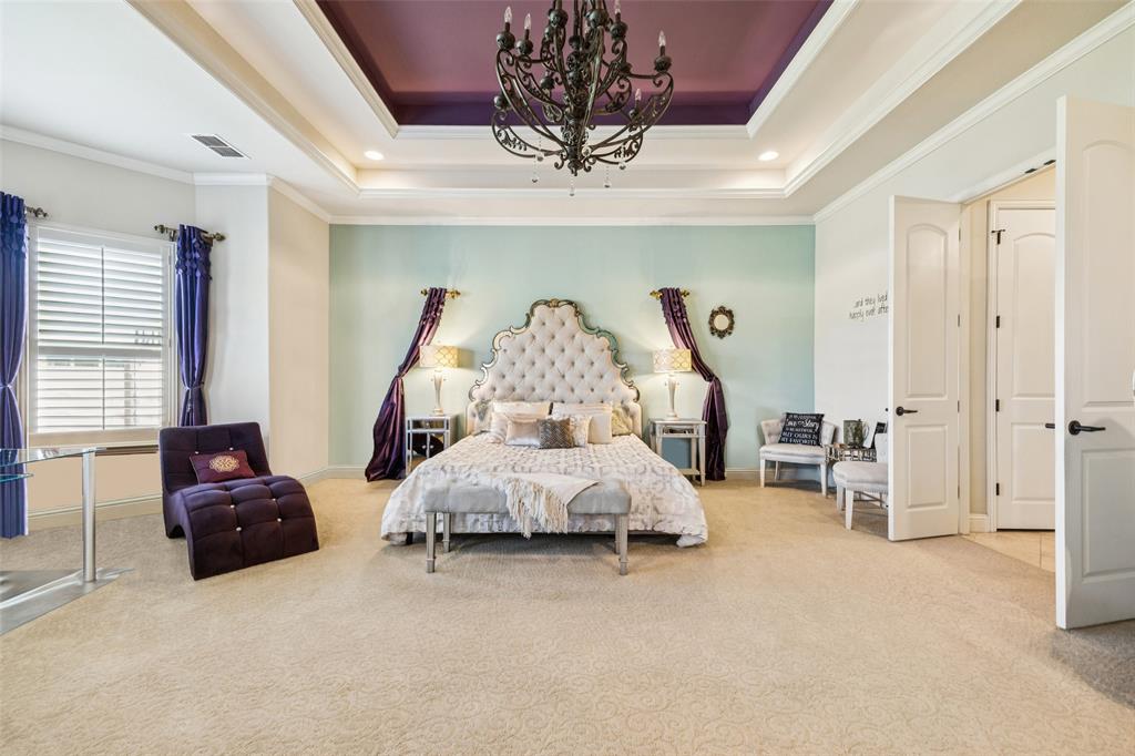 715 Simmons Road Double Oak, TX 75077 - Photo 19 of 40 a bed room with furniture and a chandelier