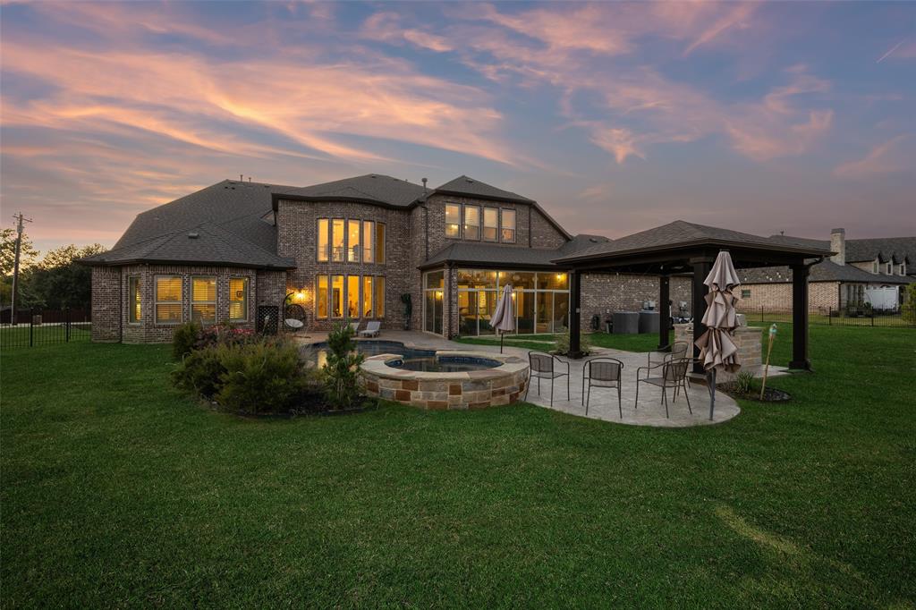 715 Simmons Road Double Oak, TX 75077 - Photo 2 of 40 a front view of a house with swimming pool having outdoor seating
