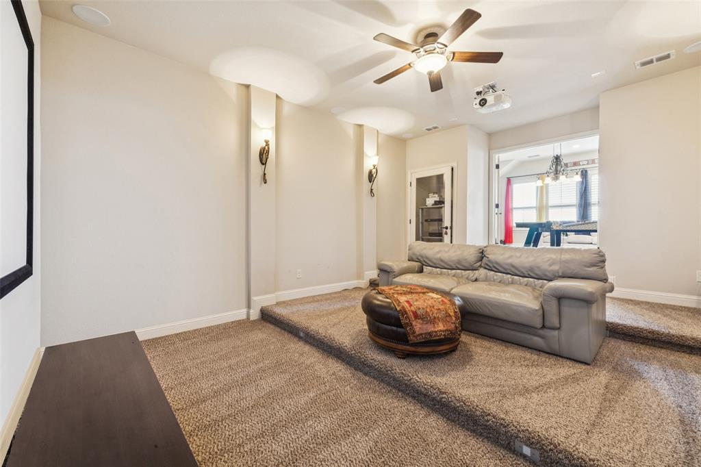 715 Simmons Road Double Oak, TX 75077 - Photo 26 of 40 a living room with furniture and a chandelier