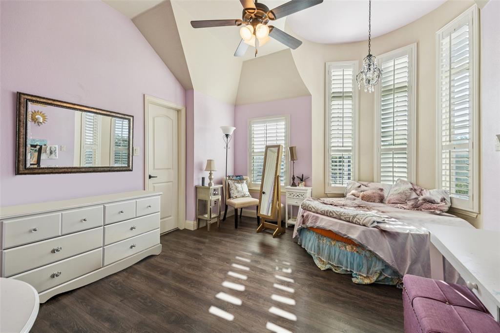 715 Simmons Road Double Oak, TX 75077 - Photo 31 of 40 a spacious bedroom with a bed and a large window
