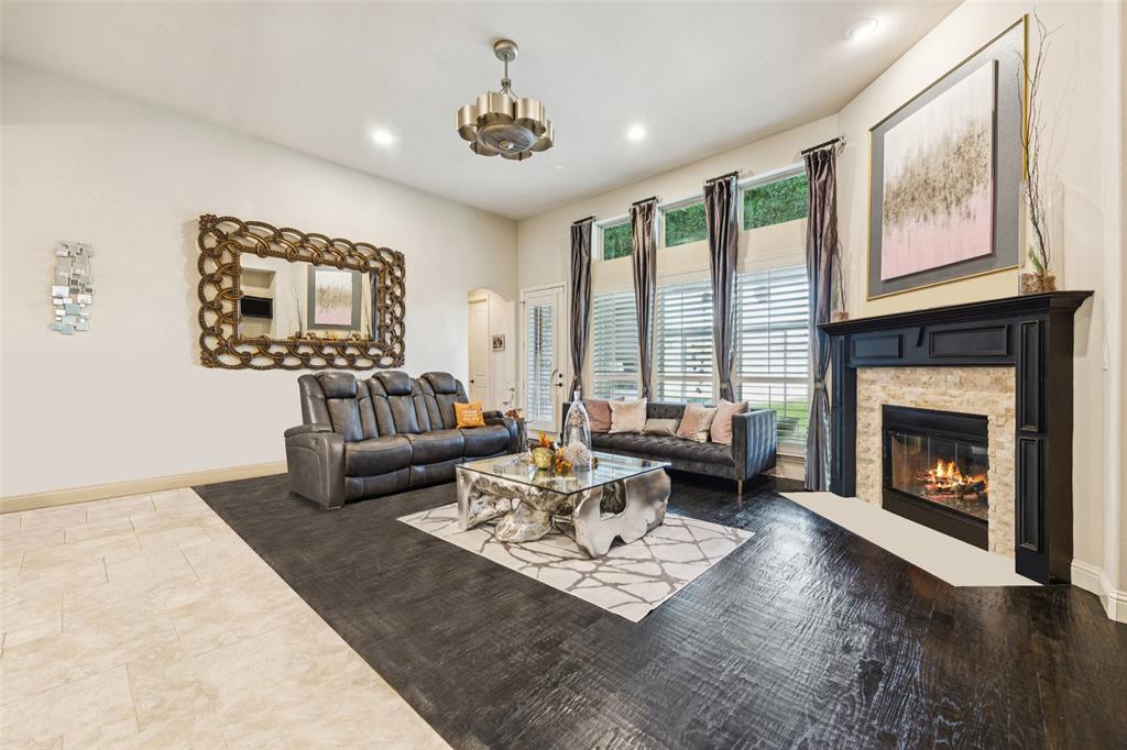 715 Simmons Road Double Oak, TX 75077 - Photo 9 of 40 a living room with furniture and a fireplace