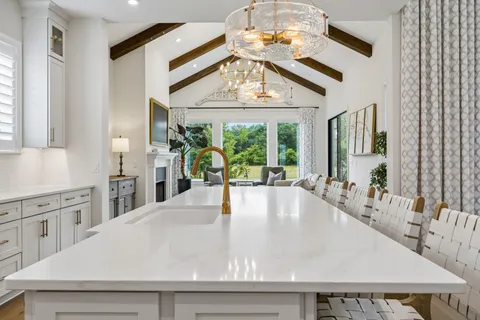 a kitchen with stainless steel appliances granite countertop a sink and a refrigerator