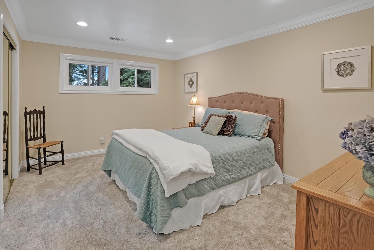 169 Sequoia Grove Ben Lomond, CA 95005 - Photo 17 of 42 a spacious bedroom with a bed and a table in it