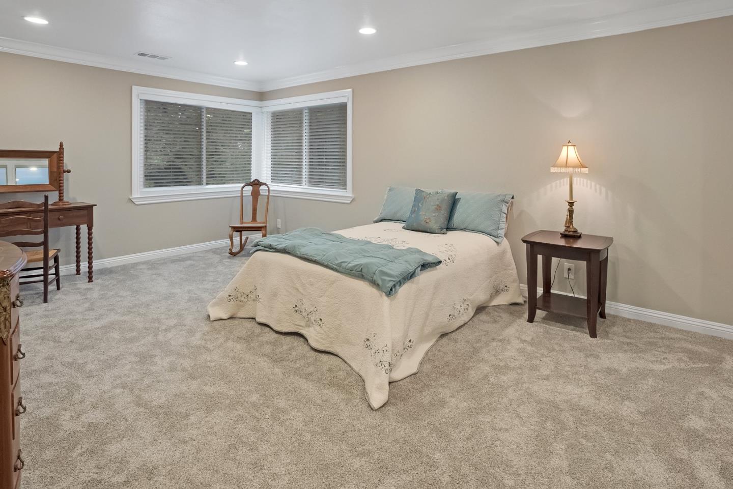 169 Sequoia Grove Ben Lomond, CA 95005 - Photo 18 of 42 a large bed sitting in a bedroom next to a window and a lamp