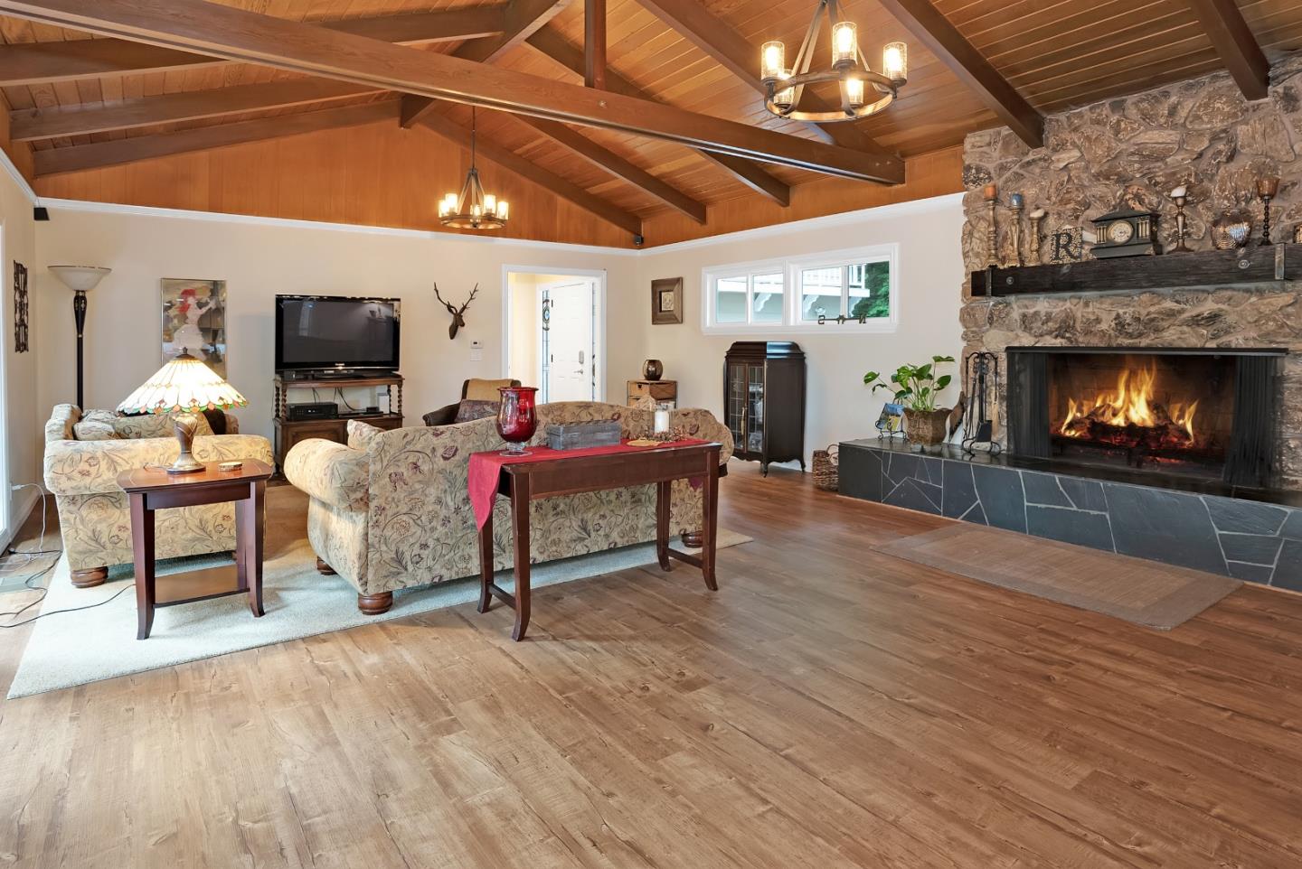 169 Sequoia Grove Ben Lomond, CA 95005 - Photo 2 of 42 a living room with furniture a fireplace and a flat screen tv