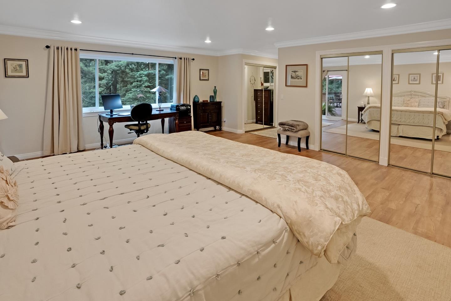 169 Sequoia Grove Ben Lomond, CA 95005 - Photo 22 of 42 a spacious bedroom with a large bed and a large window