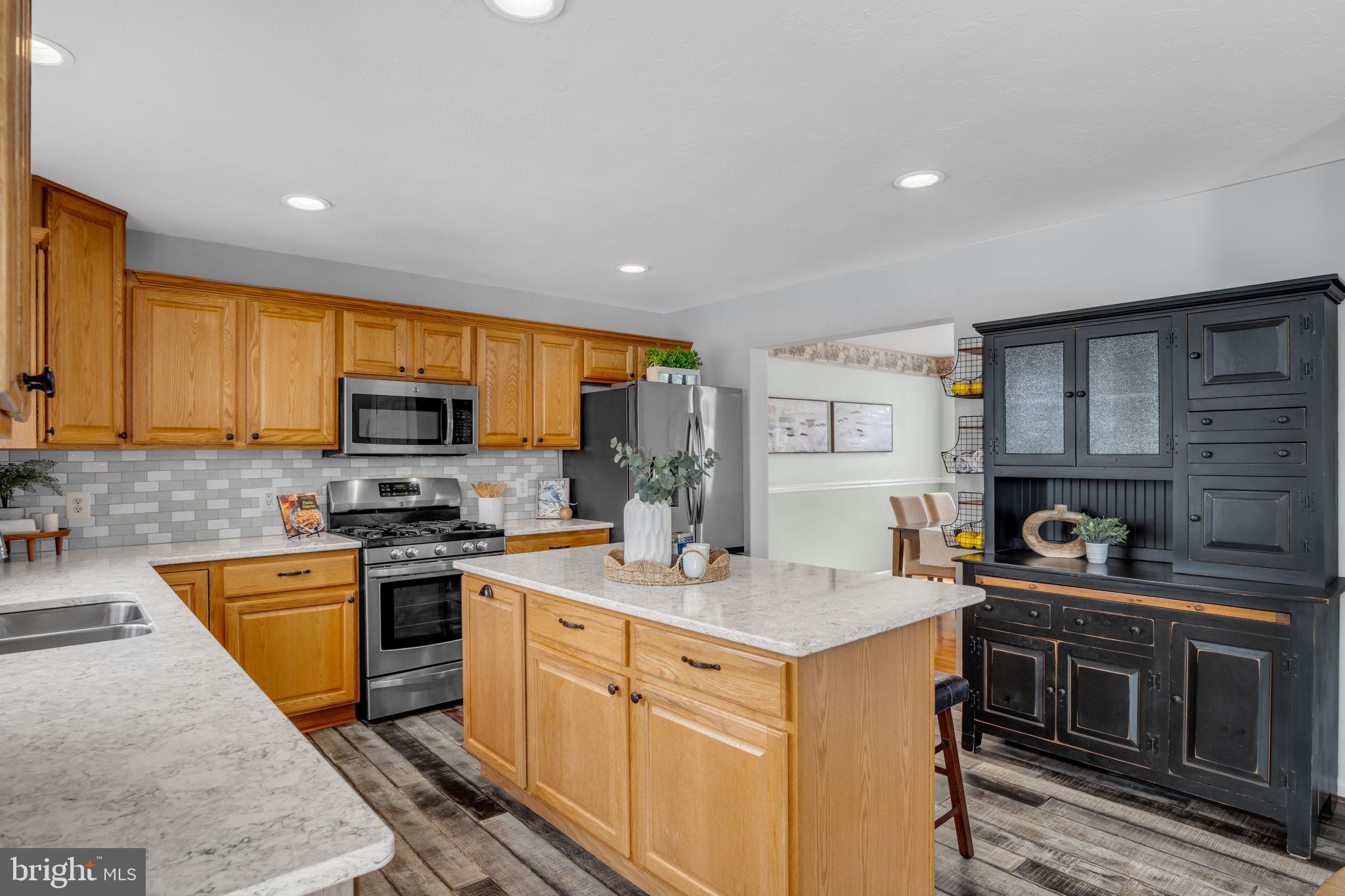 86 Barley Circle Hanover, PA 17331 - Photo 12 of 57 a kitchen with stainless steel appliances a stove sink microwave and cabinets