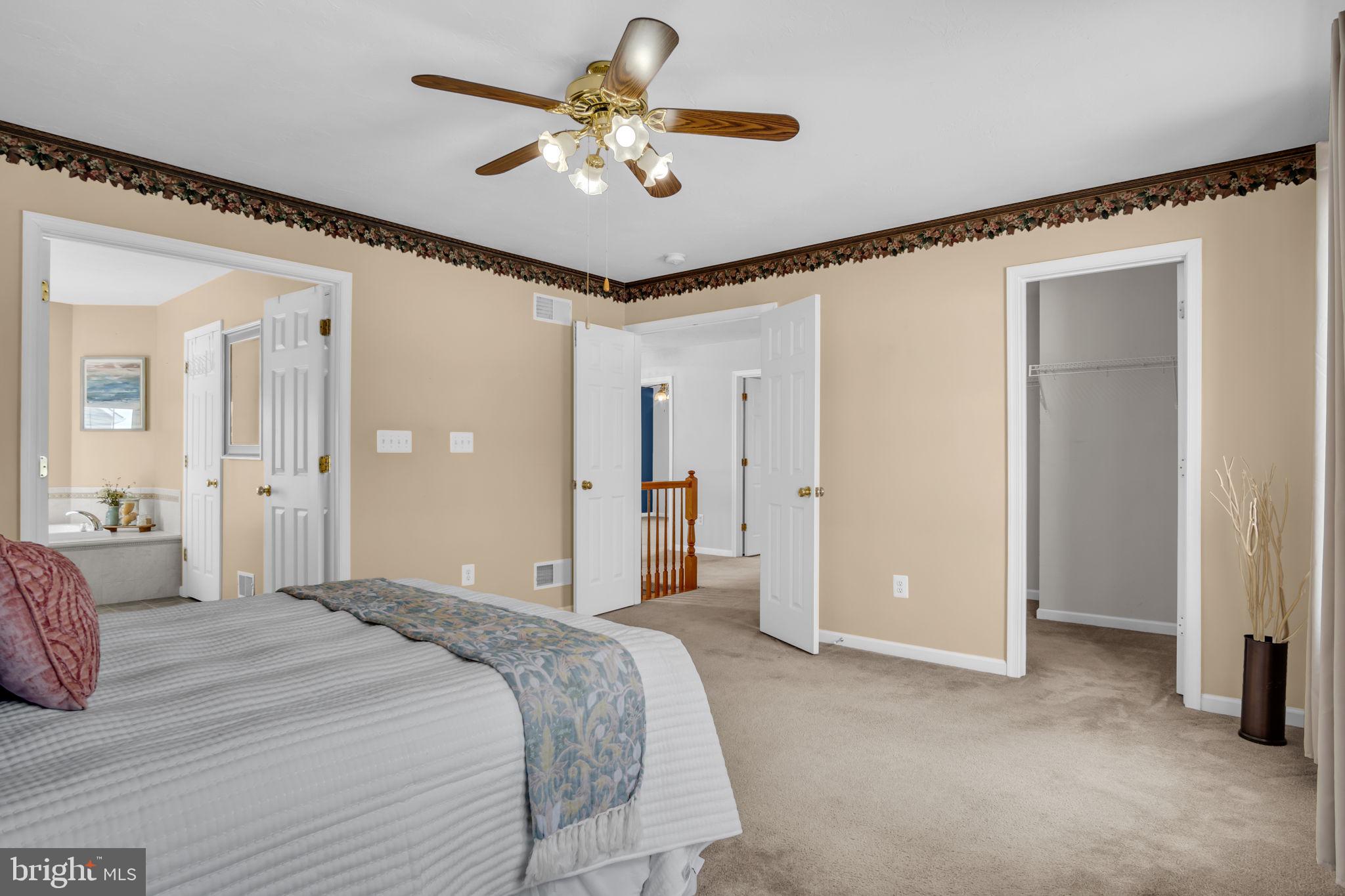 86 Barley Circle Hanover, PA 17331 - Photo 32 of 57 a bedroom with a large bed and a chandelier