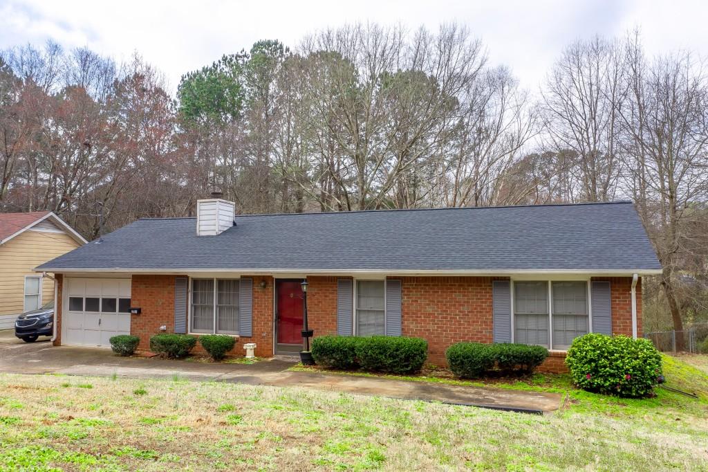 387 Johnson Road Lawrenceville, GA 30046 - Photo 1 of 1 a front view of a house with garden