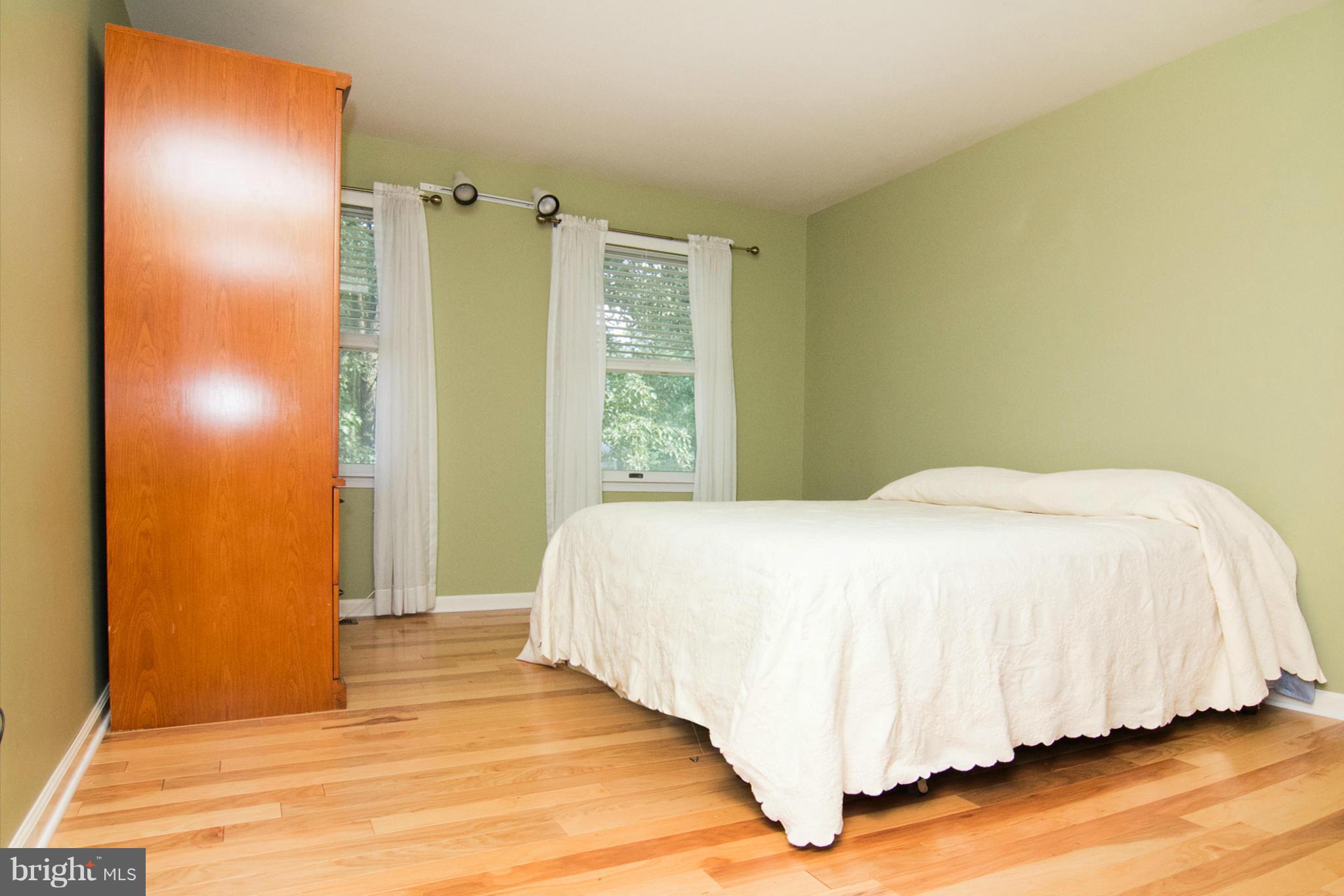 1766 Bloom Road Westminster, MD 21157 - Photo 17 of 29 a spacious bedroom with a bed and wooden floor
