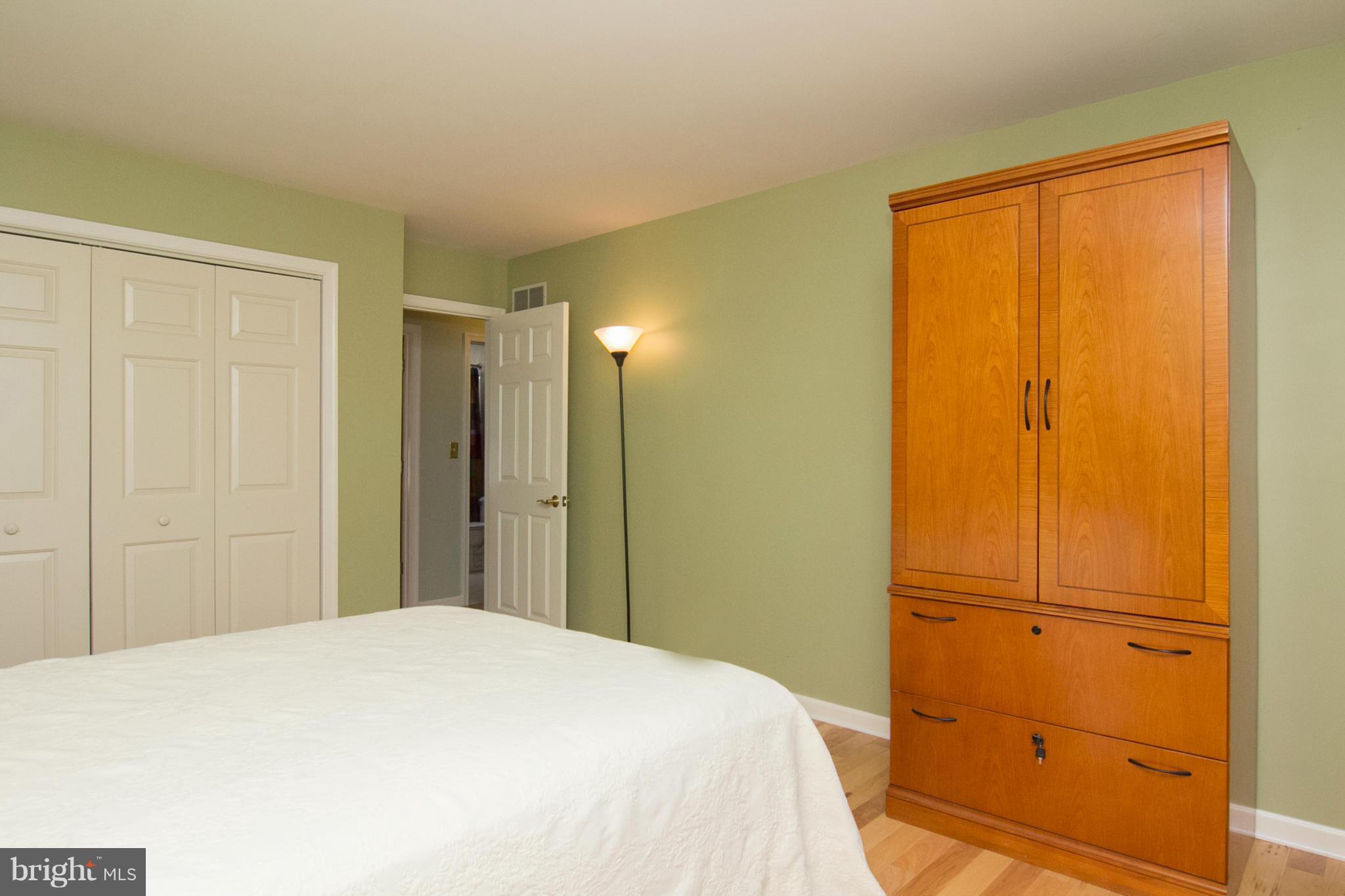 1766 Bloom Road Westminster, MD 21157 - Photo 18 of 29 a bedroom with a bed and wooden cabinets