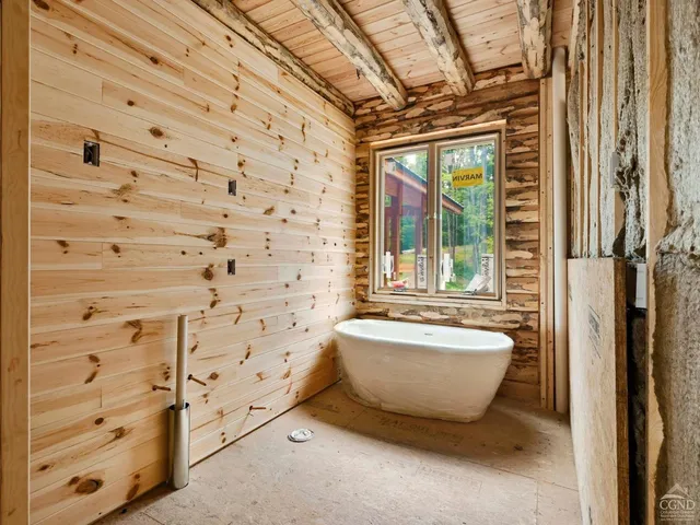 a spacious bathroom with a bathtub and window