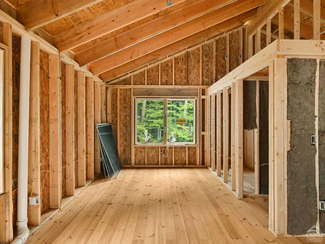 a view of a room with wooden floor and door