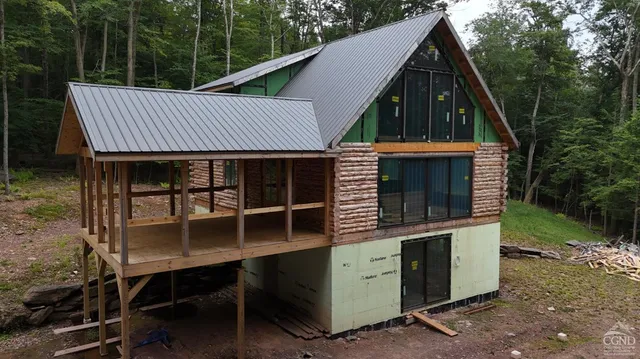a front view of a house with sitting area