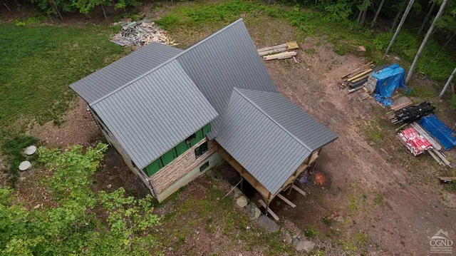 an aerial view of a house with mountain view