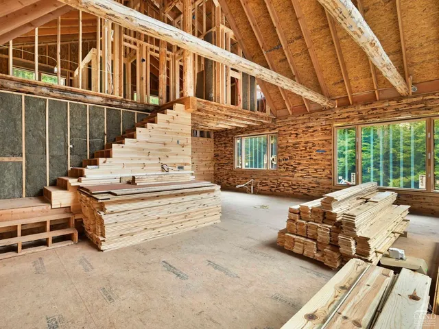 a view of a patio with couches table and chairs and wooden floor