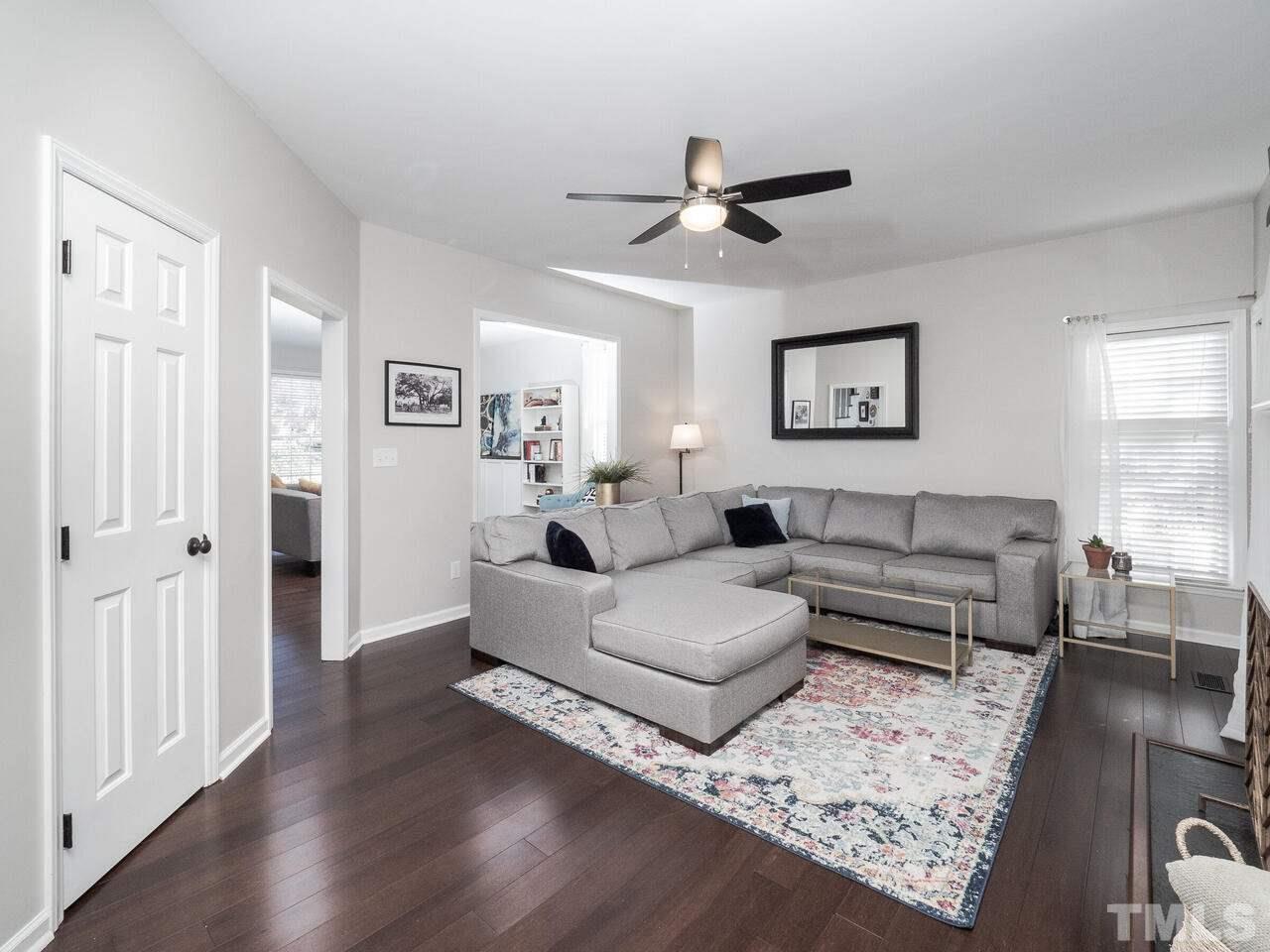 12105 North Exeter Way Raleigh, NC 27613 - Photo 14 of 27 a living room with furniture and a wooden floor