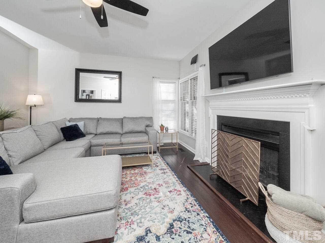 12105 North Exeter Way Raleigh, NC 27613 - Photo 15 of 27 a living room with furniture and a fireplace