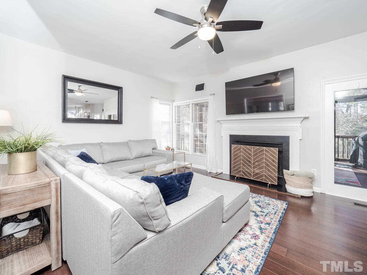 12105 North Exeter Way Raleigh, NC 27613 - Photo 16 of 27 a living room with furniture and a fireplace