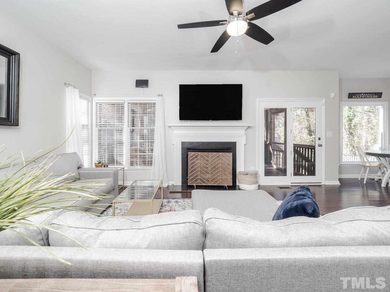 12105 North Exeter Way Raleigh, NC 27613 - Photo 17 of 27 a living room with furniture fireplace and flat screen tv