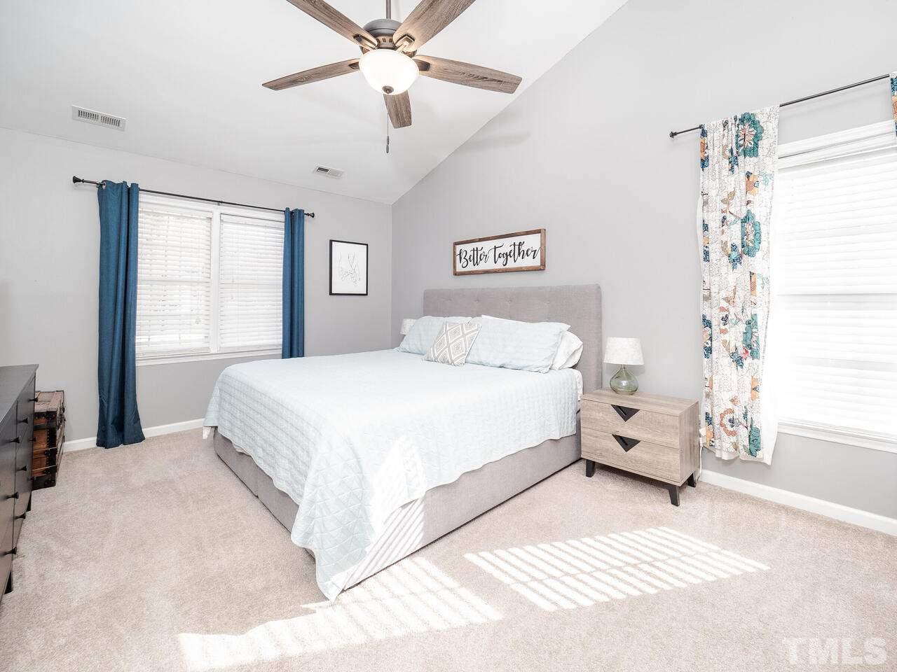 12105 North Exeter Way Raleigh, NC 27613 - Photo 18 of 27 a bedroom with a large bed and a window