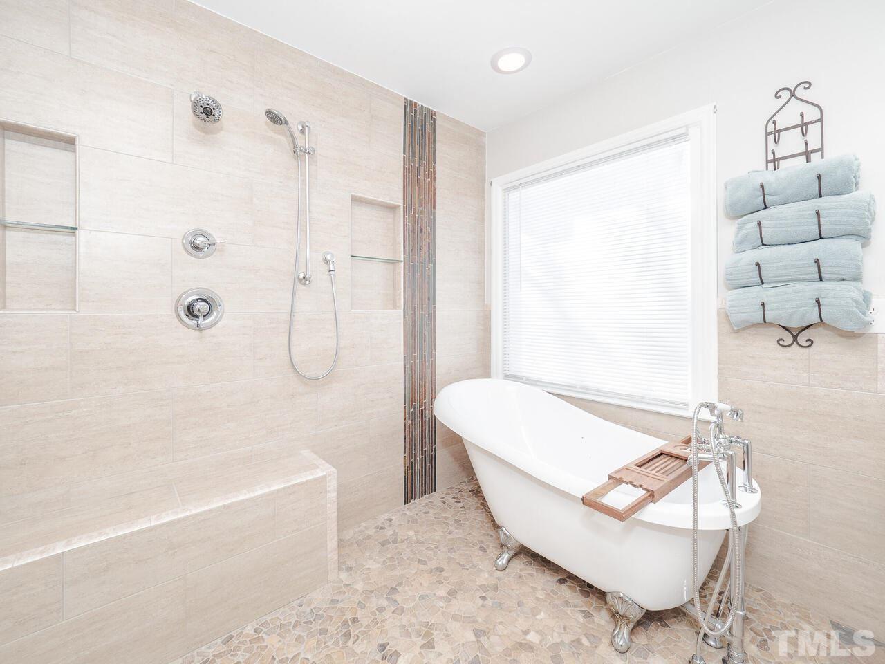 12105 North Exeter Way Raleigh, NC 27613 - Photo 21 of 27 a bathroom with a tub and a shower