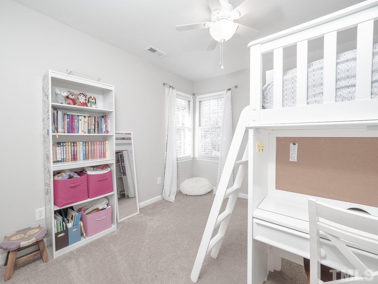 12105 North Exeter Way Raleigh, NC 27613 - Photo 22 of 27 a bedroom with furniture and a book shelf