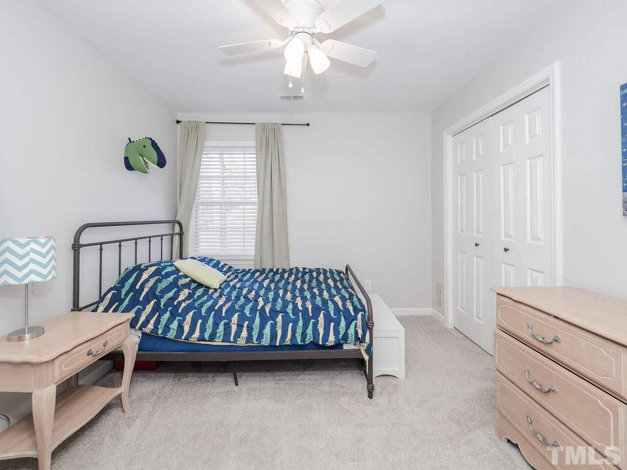 12105 North Exeter Way Raleigh, NC 27613 - Photo 23 of 27 a bed room with a bed and a window