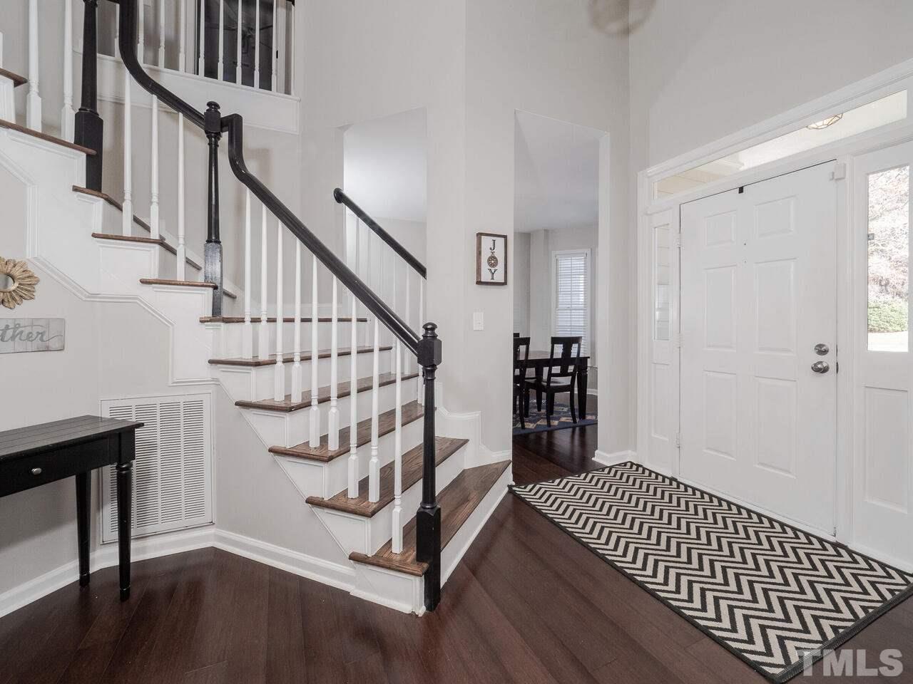12105 North Exeter Way Raleigh, NC 27613 - Photo 5 of 27 a view of entryway with wooden floor and stairs