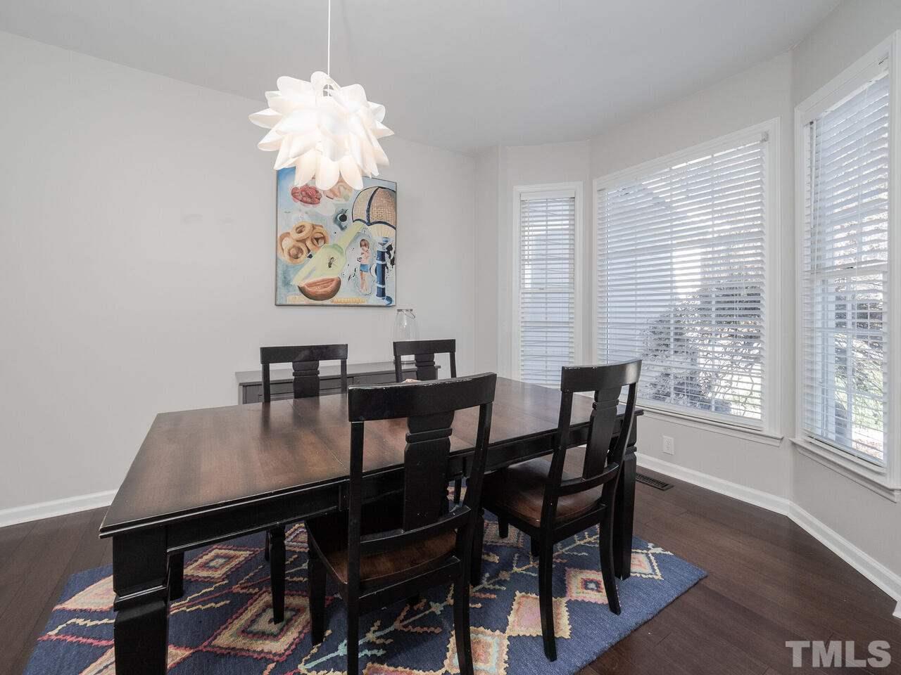 12105 North Exeter Way Raleigh, NC 27613 - Photo 6 of 27 a view of a dining room with furniture and wooden floor