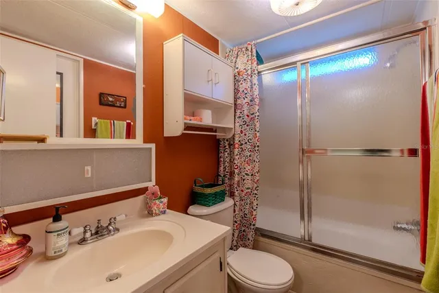 a room with stainless steel appliances kitchen island granite countertop a refrigerator a stove and a sink