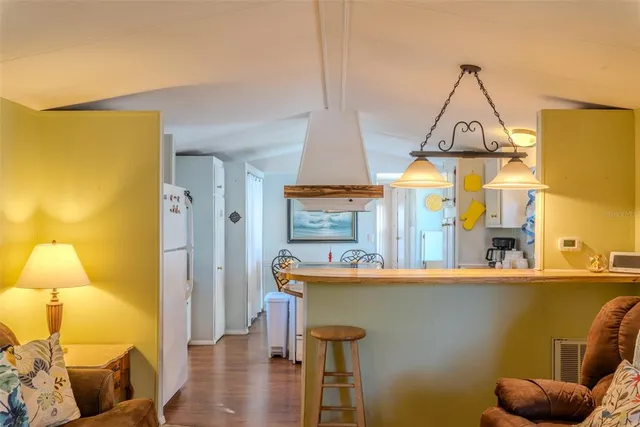 a view of a kitchen with a sink and wooden floor