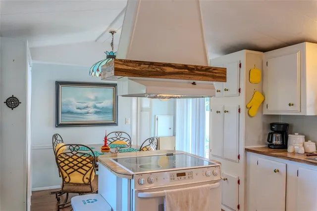a kitchen with cabinets and window